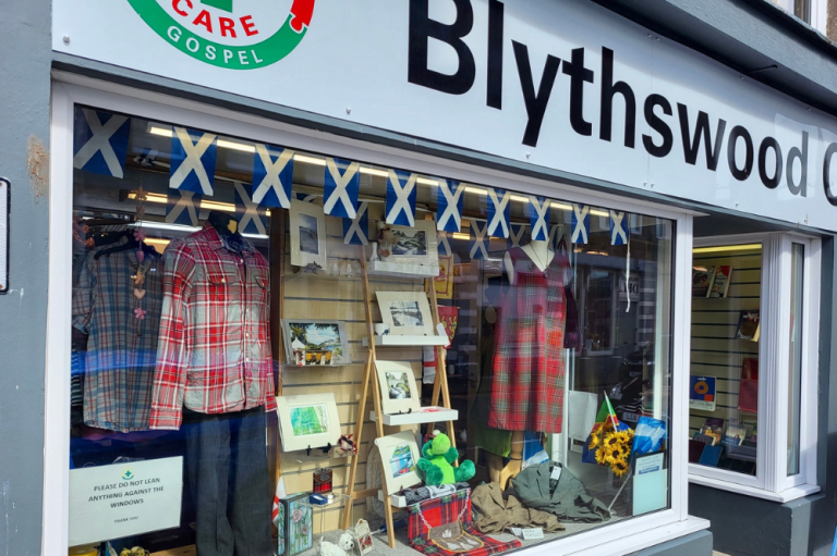 Blythswood charity shop window, full of stock.
