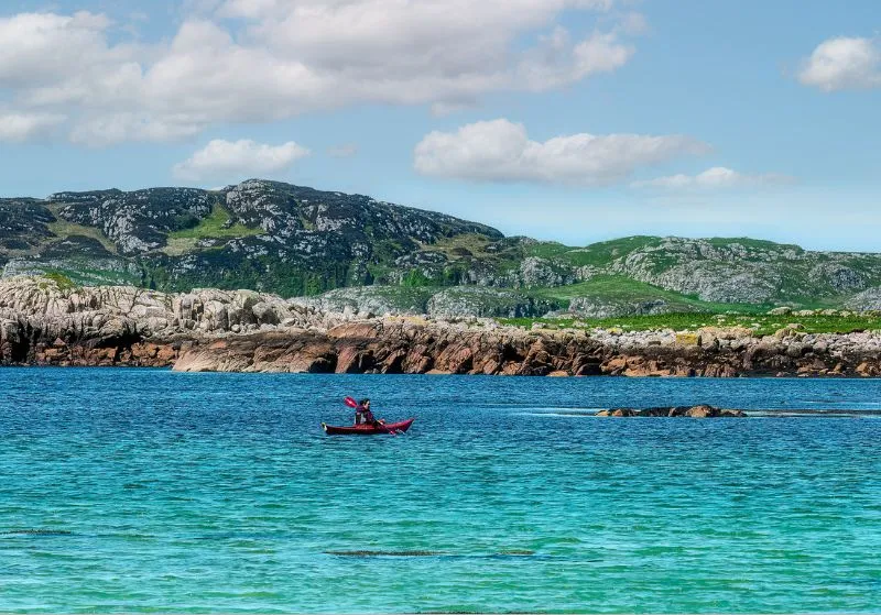 Lone kayaker on the blue waters of Mull